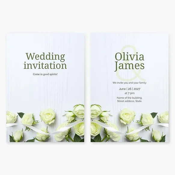 Wedding invitation with yellow roses and a white ribbon on a bleached wood background